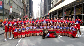 A team photo of the Cheer New York team and their mascot.