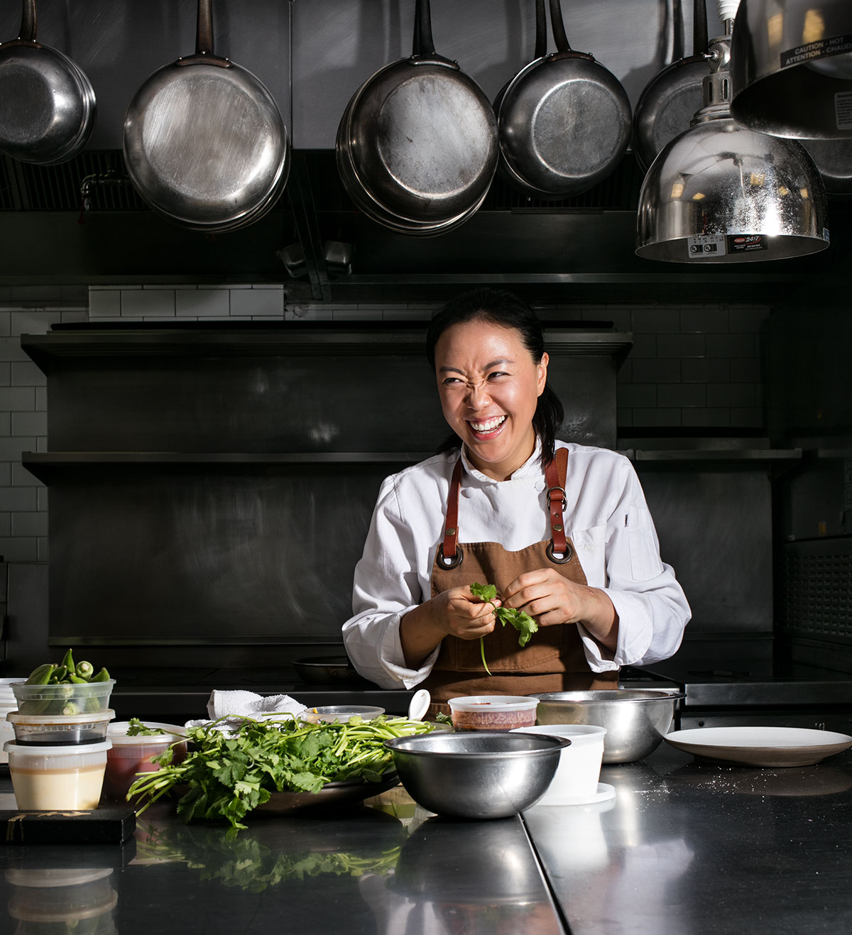 Chef Jae-Jung in her kitchen with fresh cilantro. 