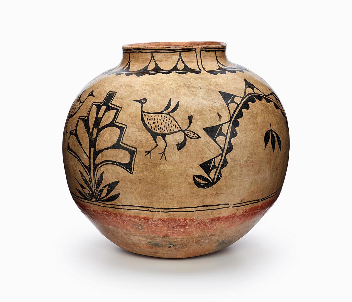 A three-color Cochiti polychrome storage jar featuring white slip with black and red painted decoration.