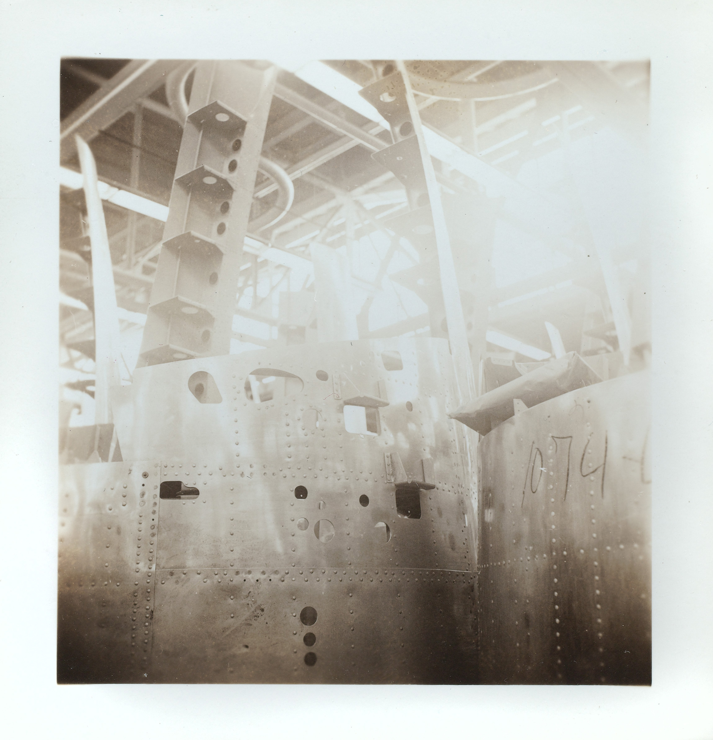 Black and white photograph of nacelles in an aircraft plant.
