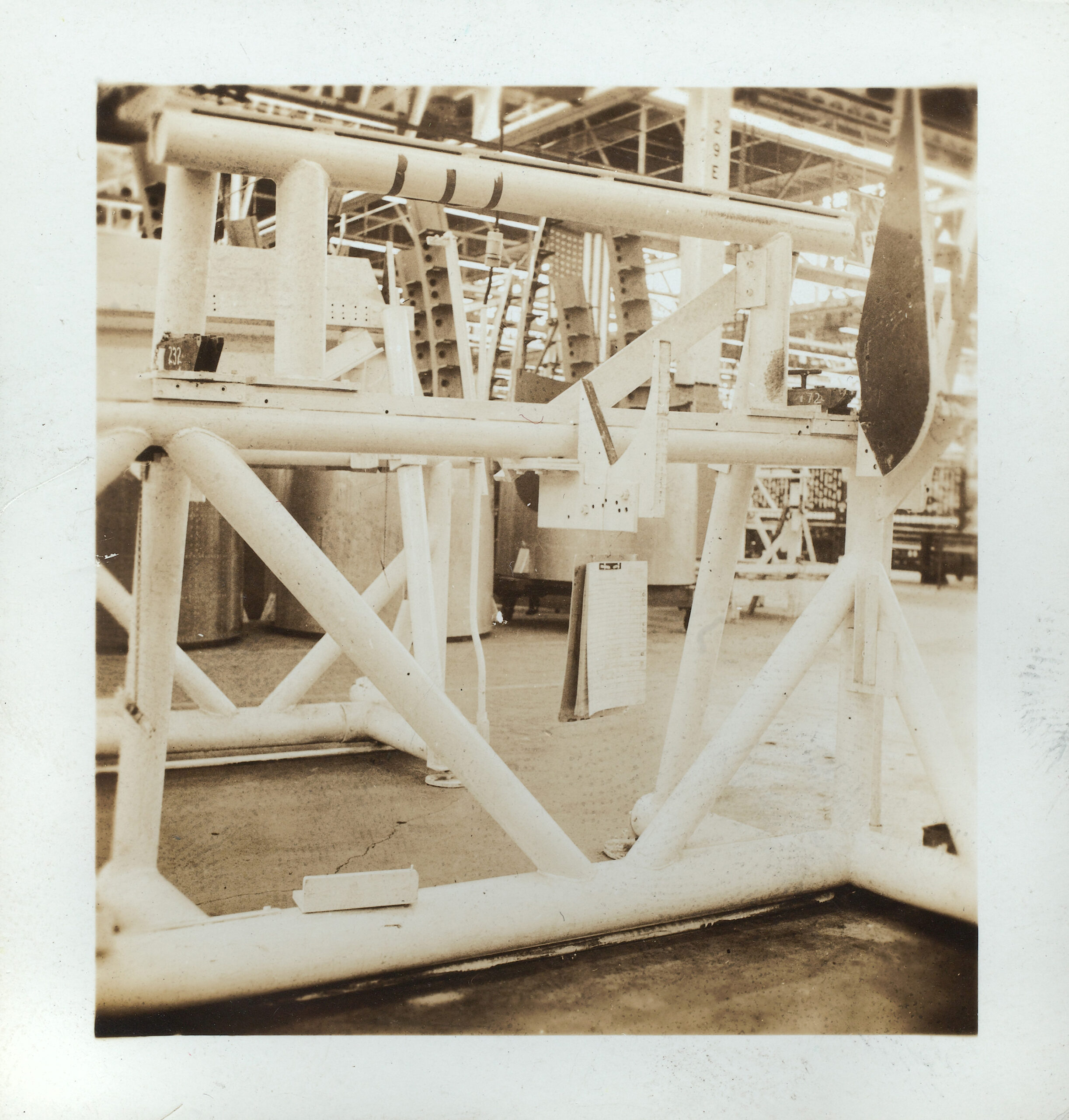 Sepia photograph of the ceiling fixtures in an aircraft plant.