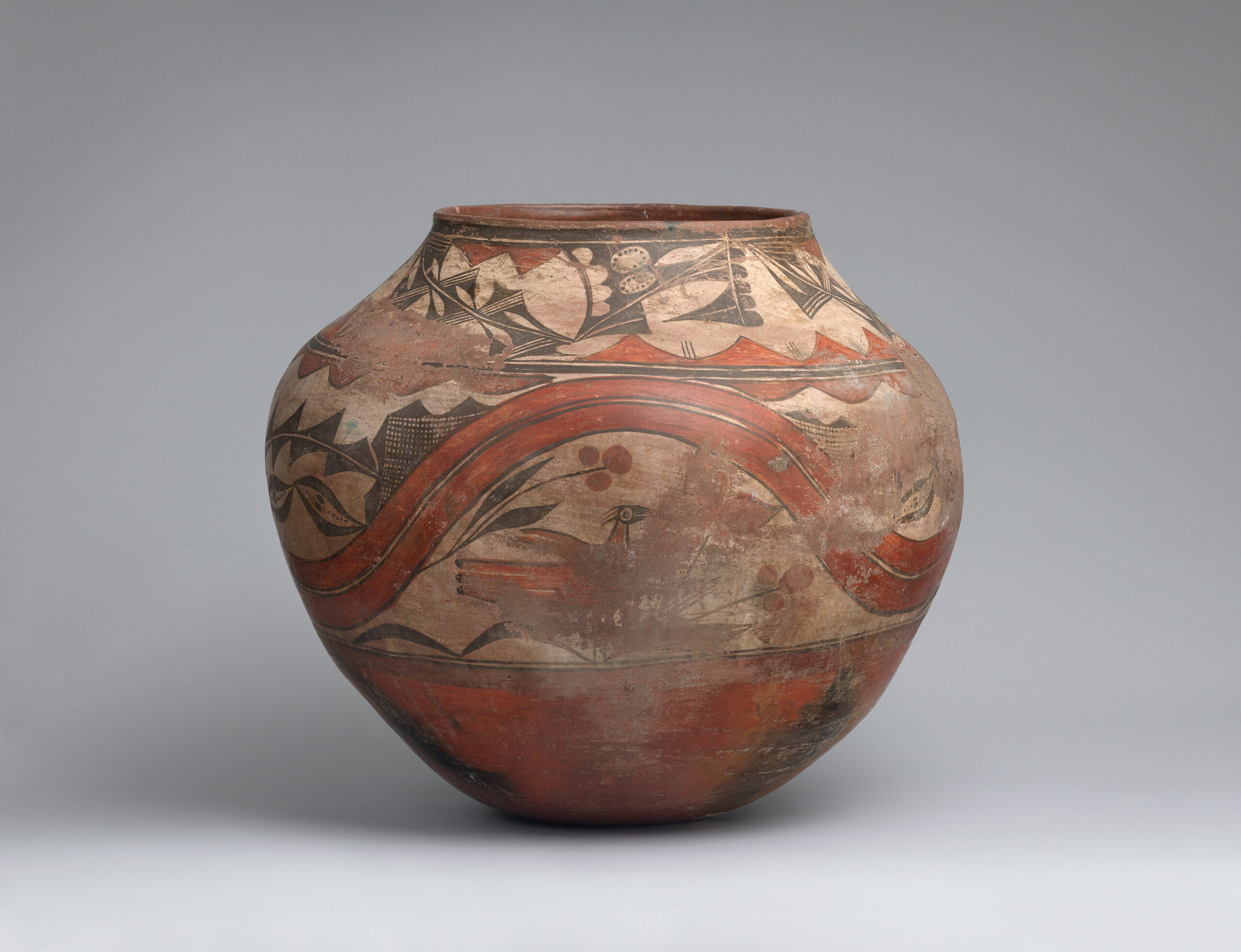 A Zia jar decorated with two bands of designs, including birds, flowers, plants, and geometric shapes.