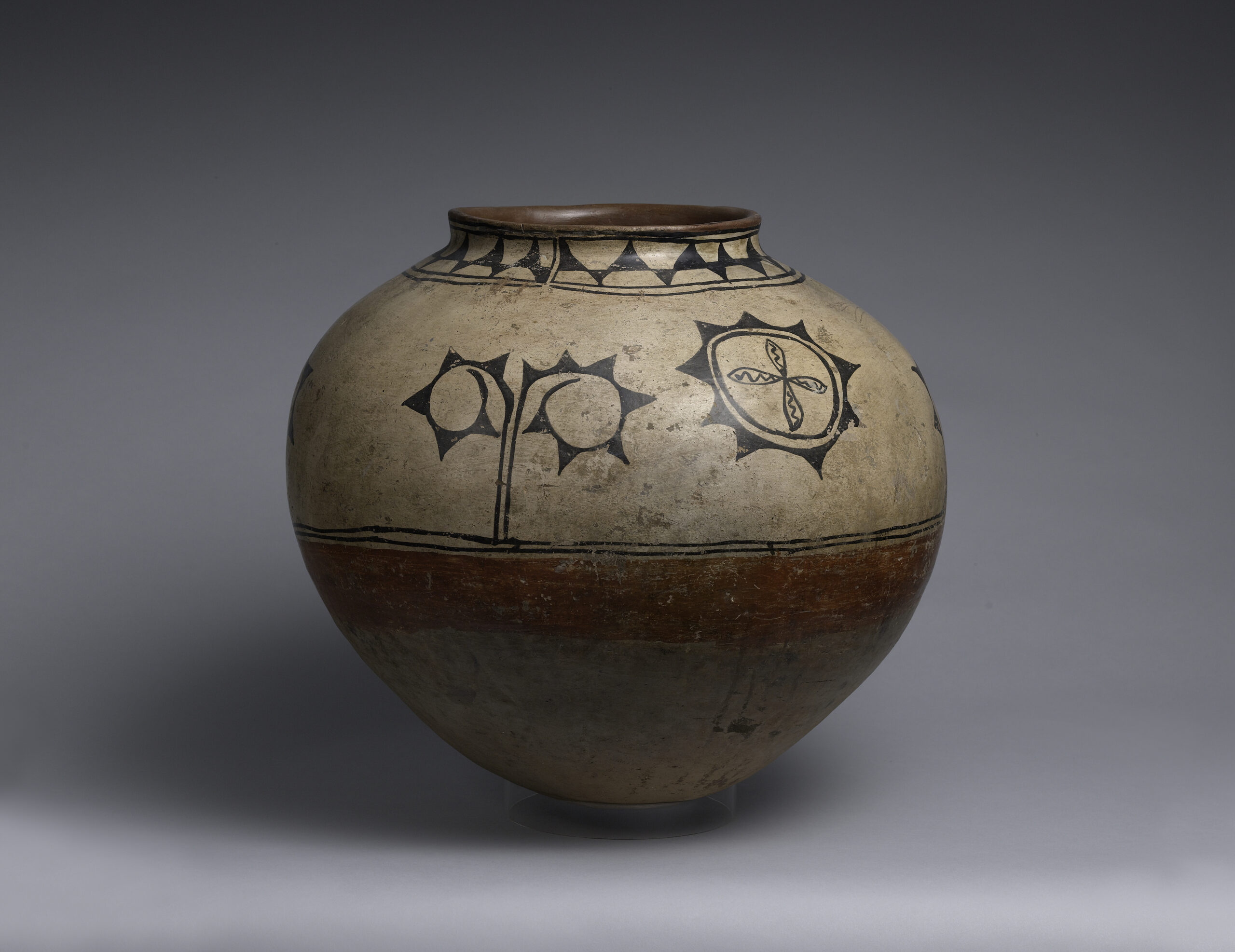 A Cochiti storage jar decorated with geometric and plant designs.