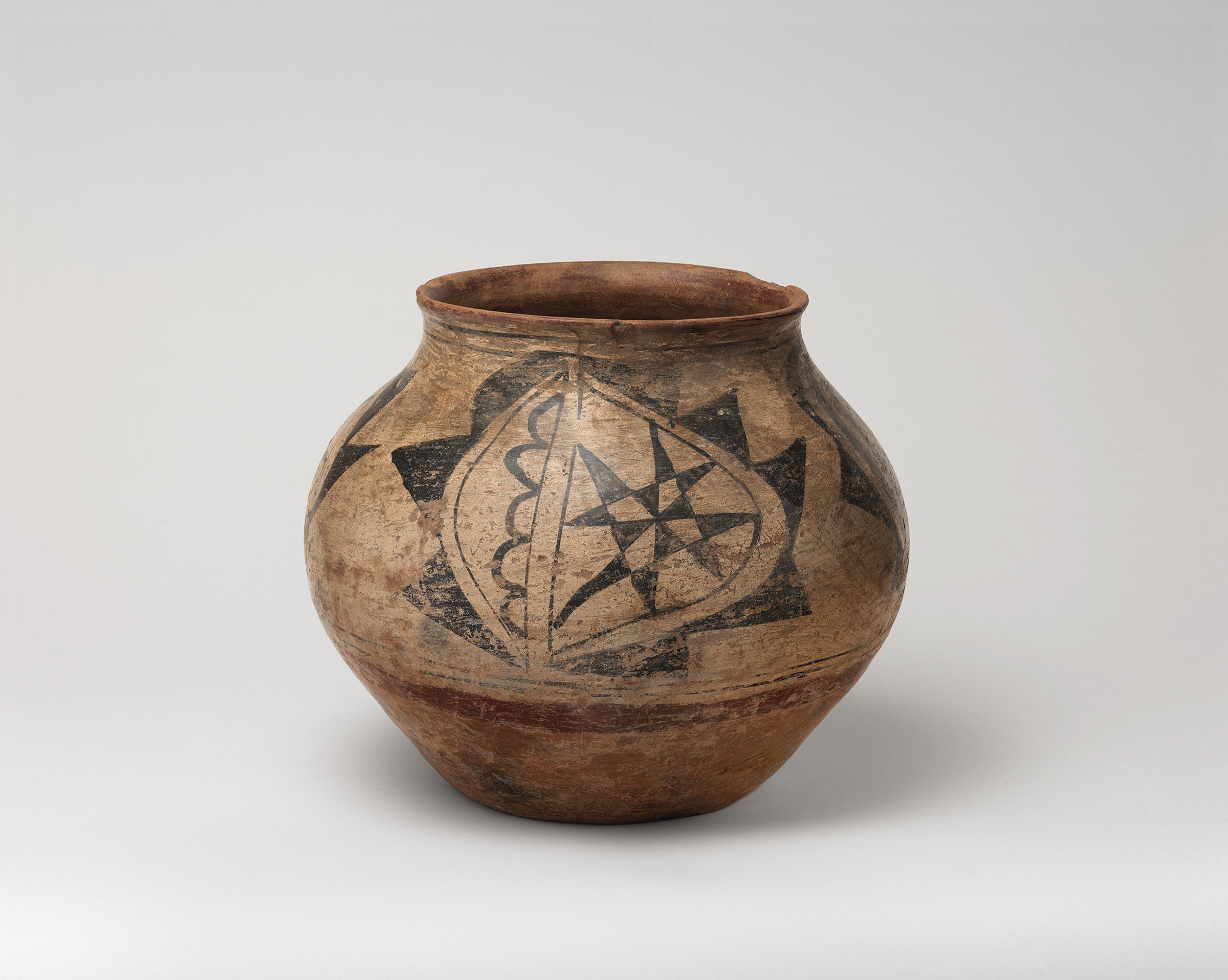 Santa Ana polychrome water jar featuring white slip with black and red painted decoration.