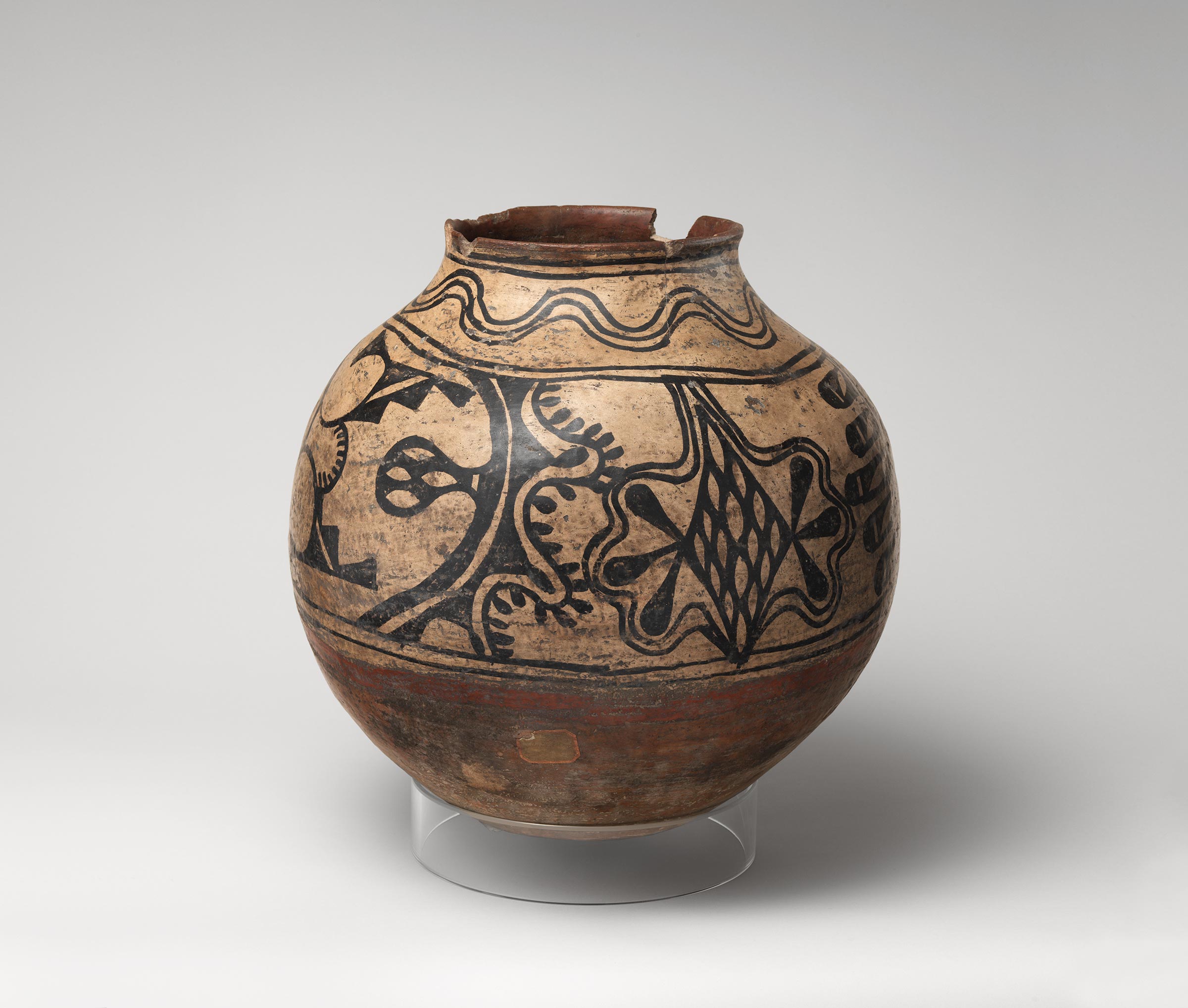 Cochiti polychrome storage jar featuring white slip with black and red painted decoration.