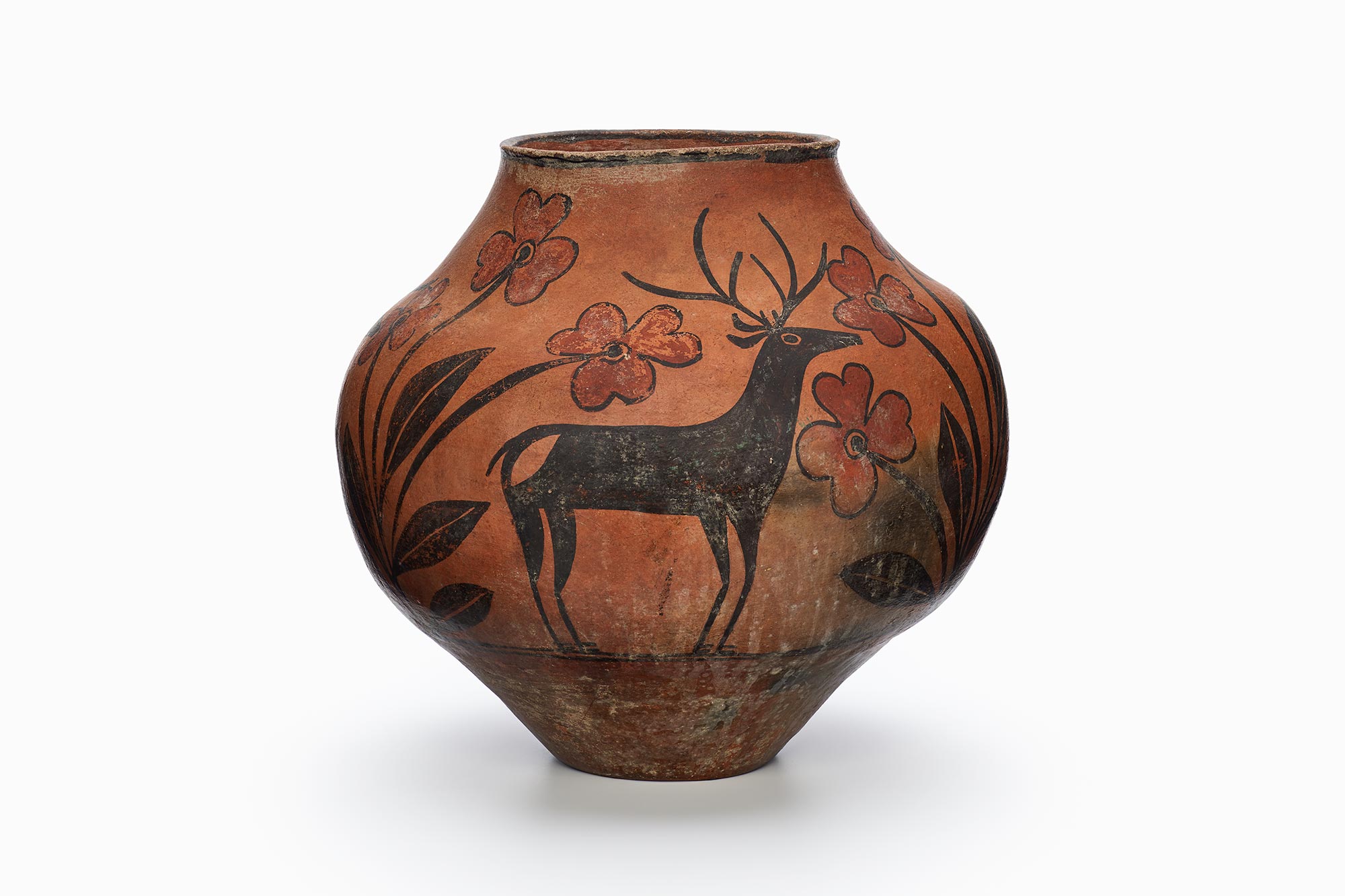 A Zia pot with a rarely-painted deer in the center surrounded by black and brown patterns.