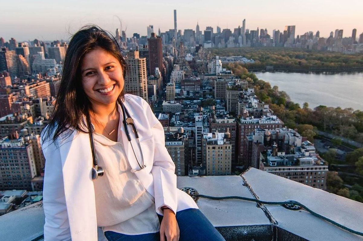 Denisse Rojas Marquez at Medical School with a view of Manhattan in the background.
