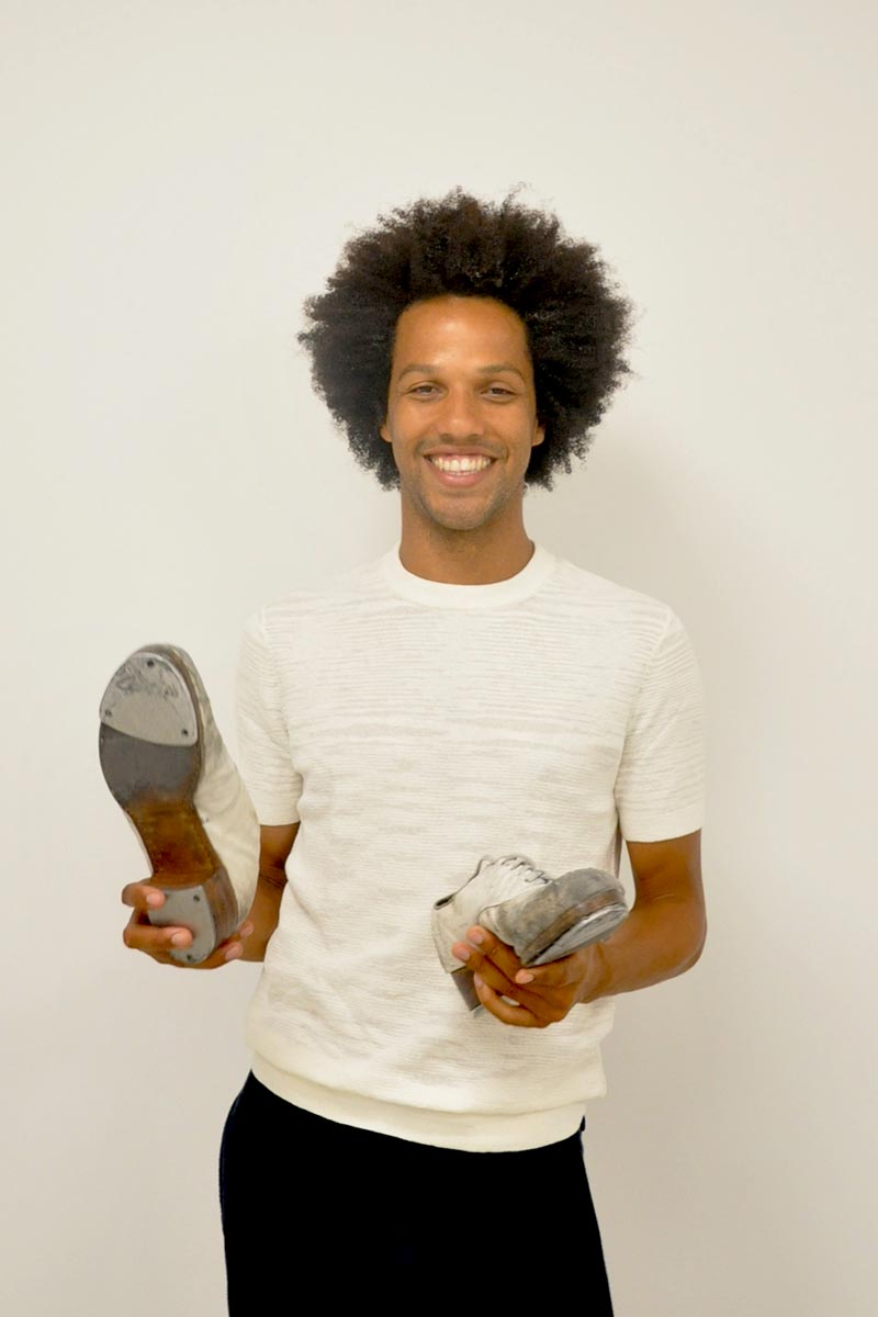 Photo of Leonardo Sandoval holding his tap shoes.