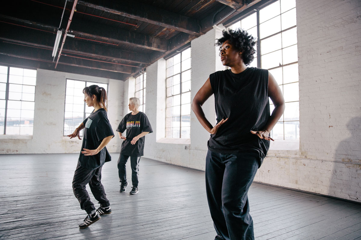 Tatiana Desardouin dances in a studio with two other performers.