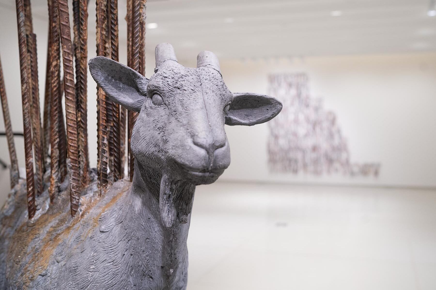 A sculpture of a goat with rebar sticking out of it's back.