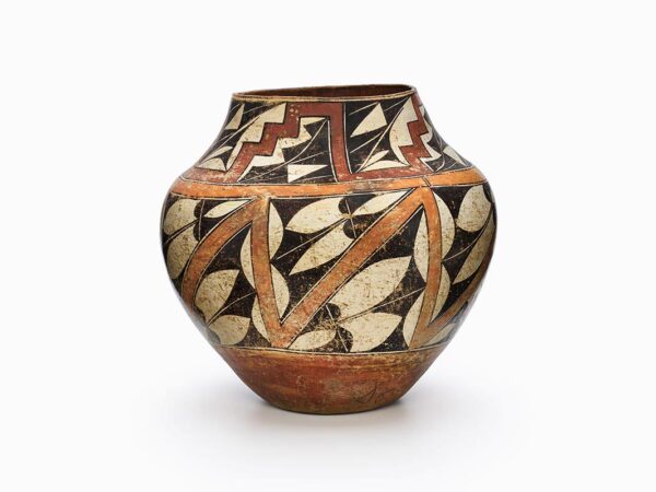 An Acoma pot decorated in white, red, orange, and black geometric shapes.