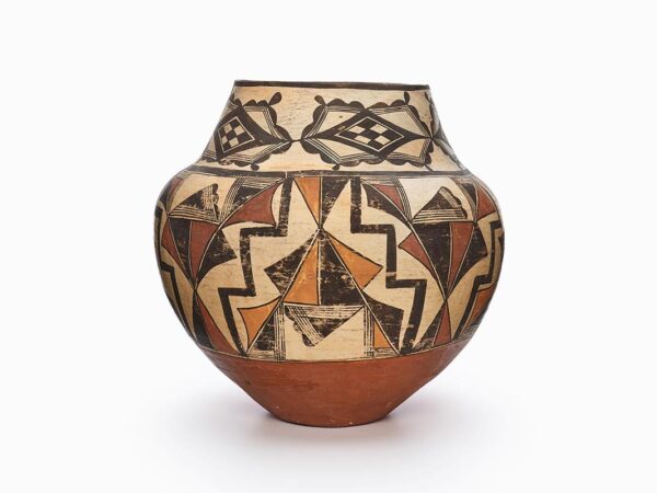 An Acoma jar decorated with black, beige, rust-brown, and red geometric patterns.