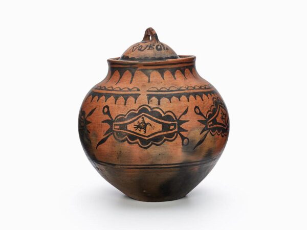 A San Ildefonso red lidded jar with black designs.