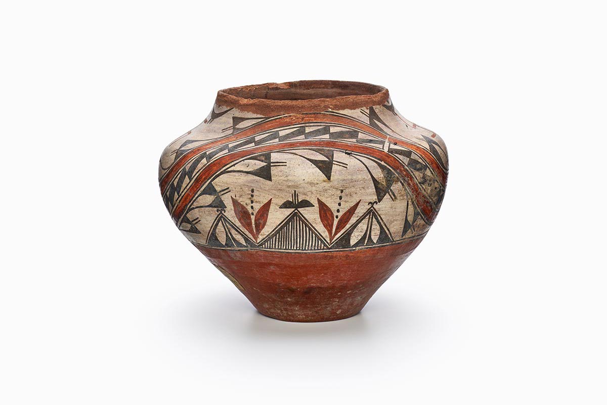 A Zia olla with an abstract design and two whirling log symbols painted in beige, brown, and black.