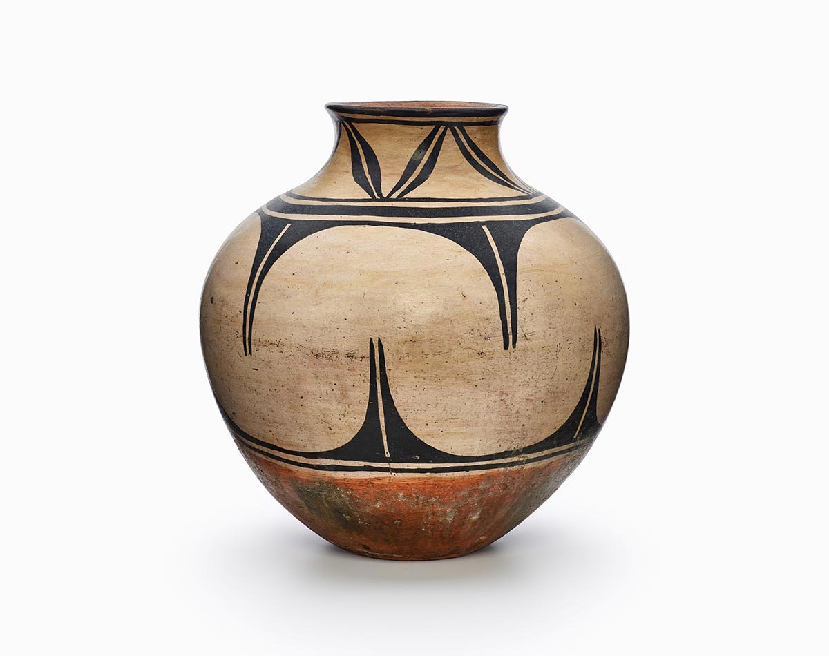 A three-color Kewa polychrome storage jar featuring white slip with black and red painted decoration.
