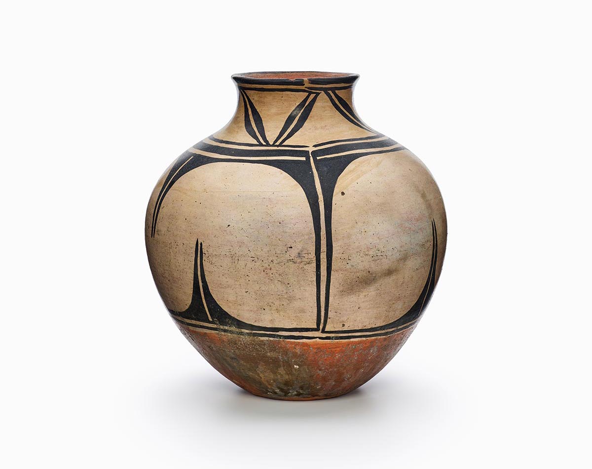 A Kewa polychrome storage jar with black and red painted decoration.