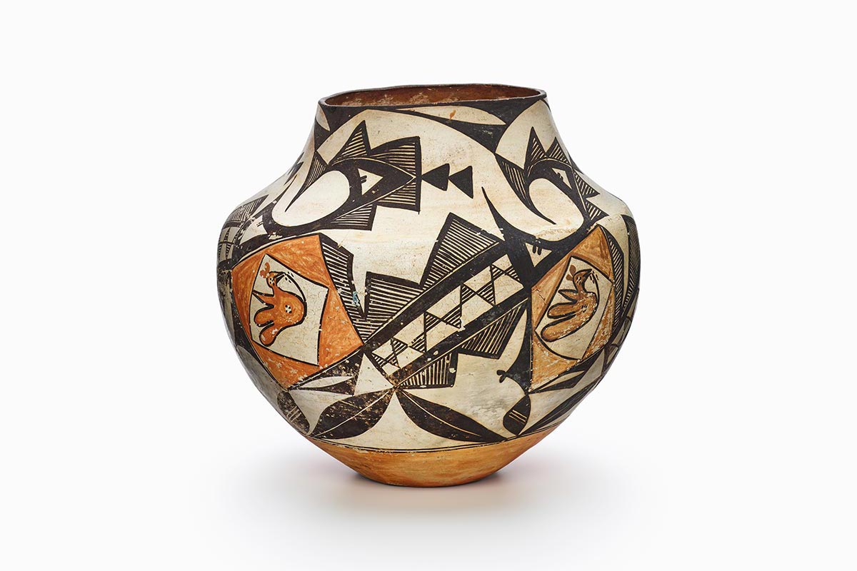 An Acoma jar with geometric bands in black encircling an orange parrot.