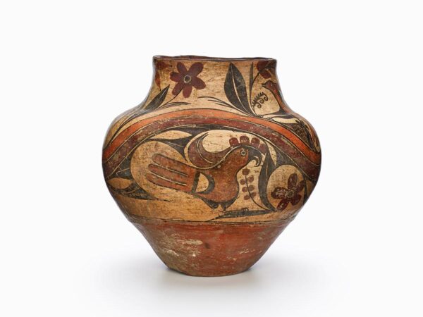 An Acoma polychrome olla decorated with birds and flora in black, browns, and rust.