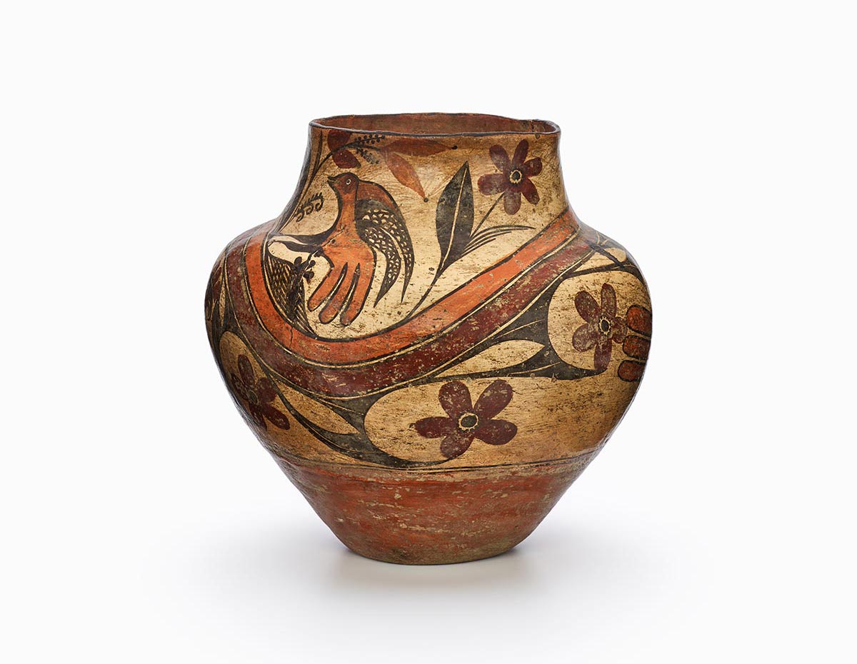 A four-color Acoma polychrome olla (water jar) featuring white slip with black, red, and orange painted decoration.
