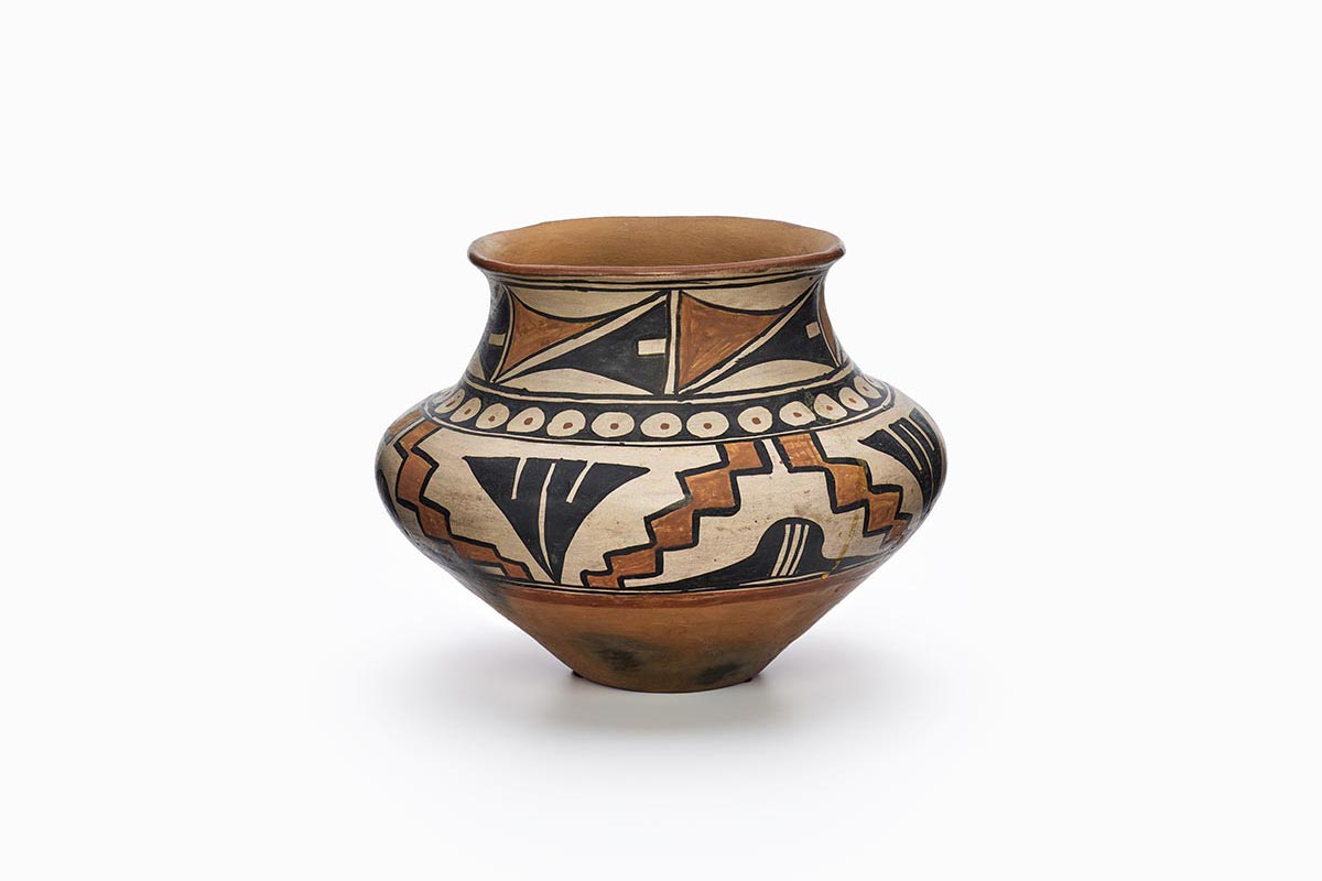 A San Ildefonso pot with two bands of decoration and black circles with red dots in the middle.
