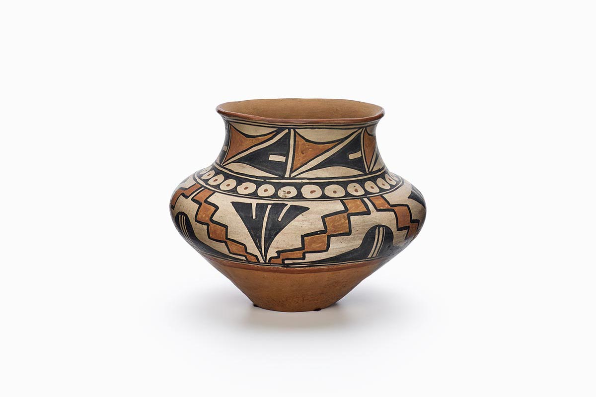 A San Ildefonso pot with decorations of feathers and leaves.