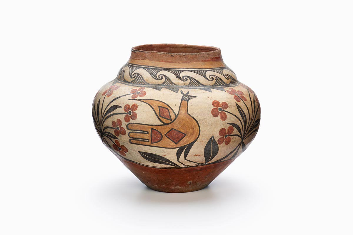 A Zia pot with a large bird and flowers painted in brown, red, and black.