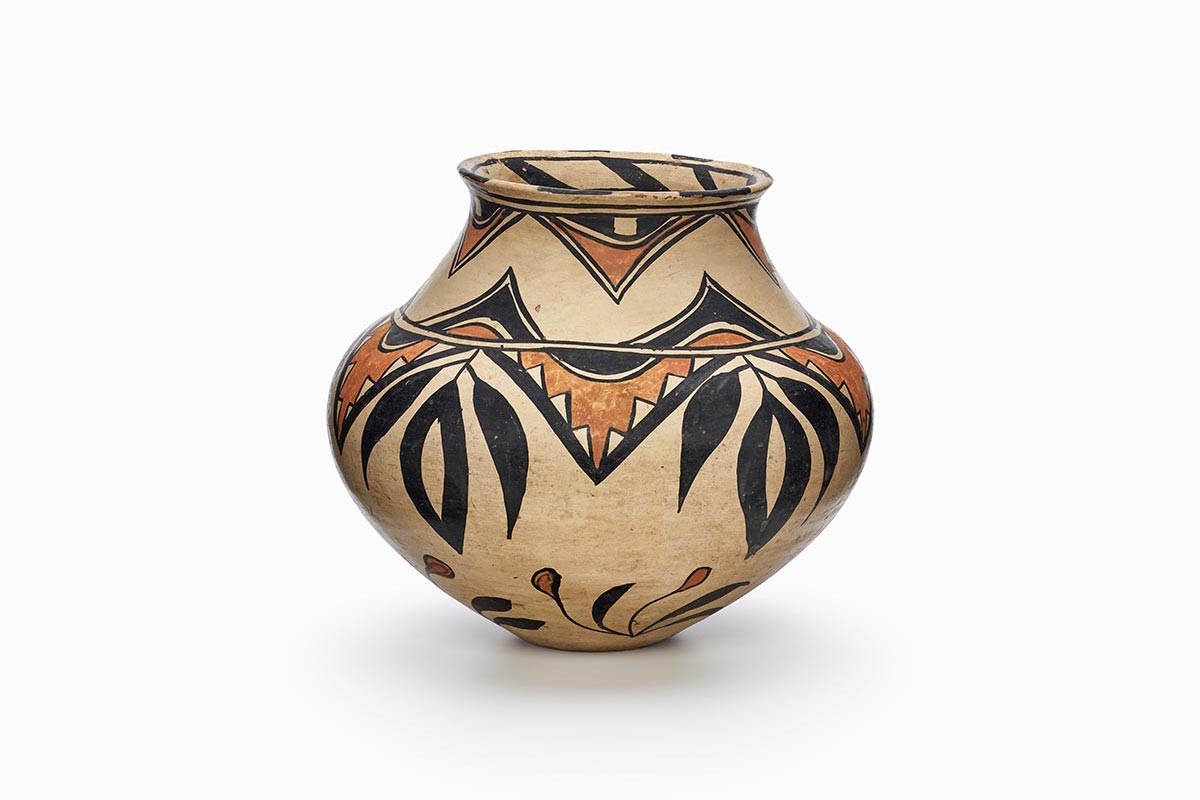 A San Ildefonso pot with geometric patterns, flora and a design on the inner rim.