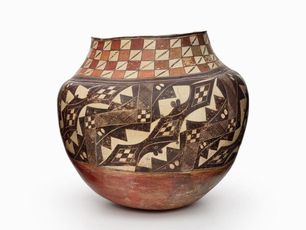An Acoma olla with a brown and beige checkboard pattern atop a black and beige geometric design.