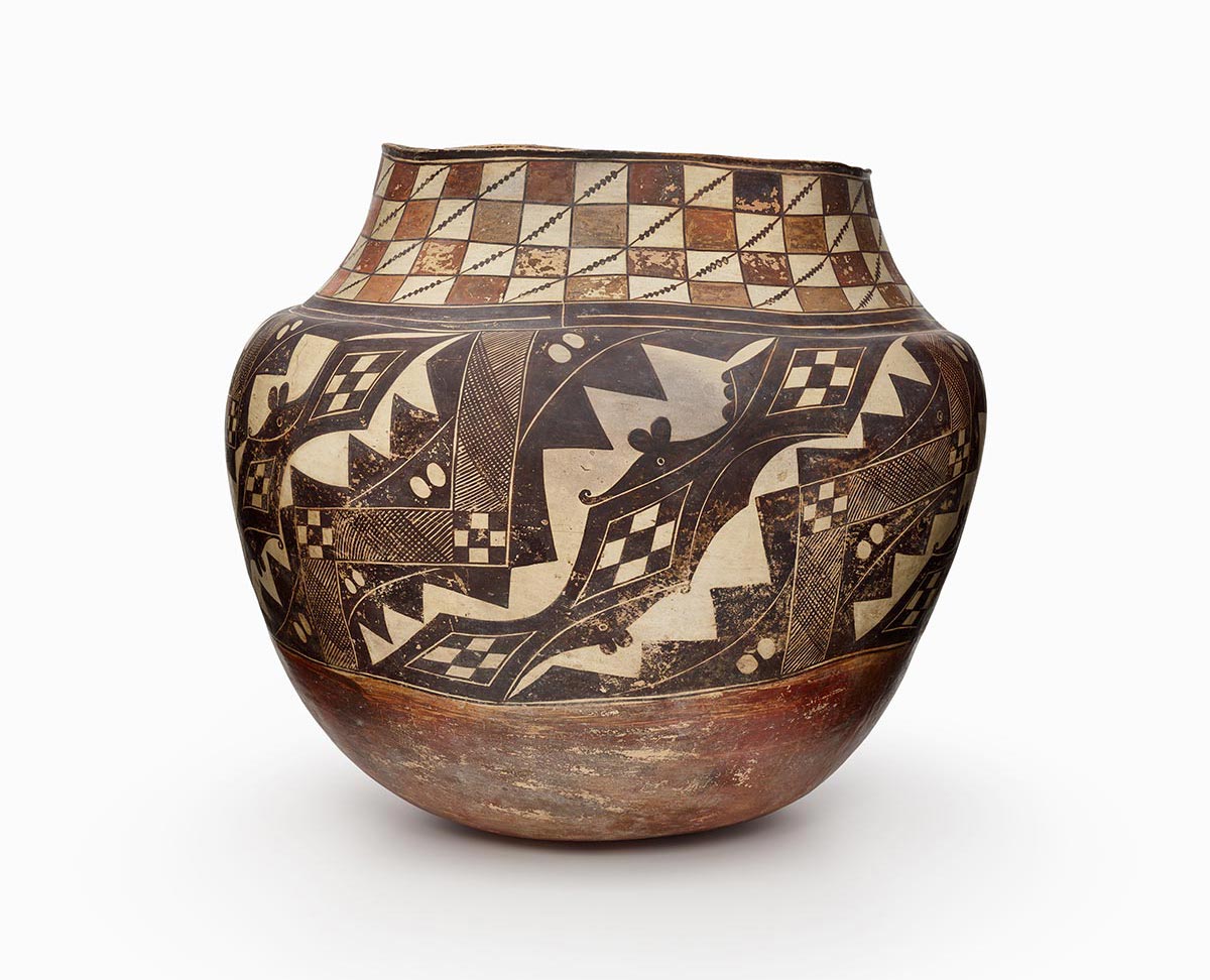 An Acoma jar with colored squares that are both red and orange.