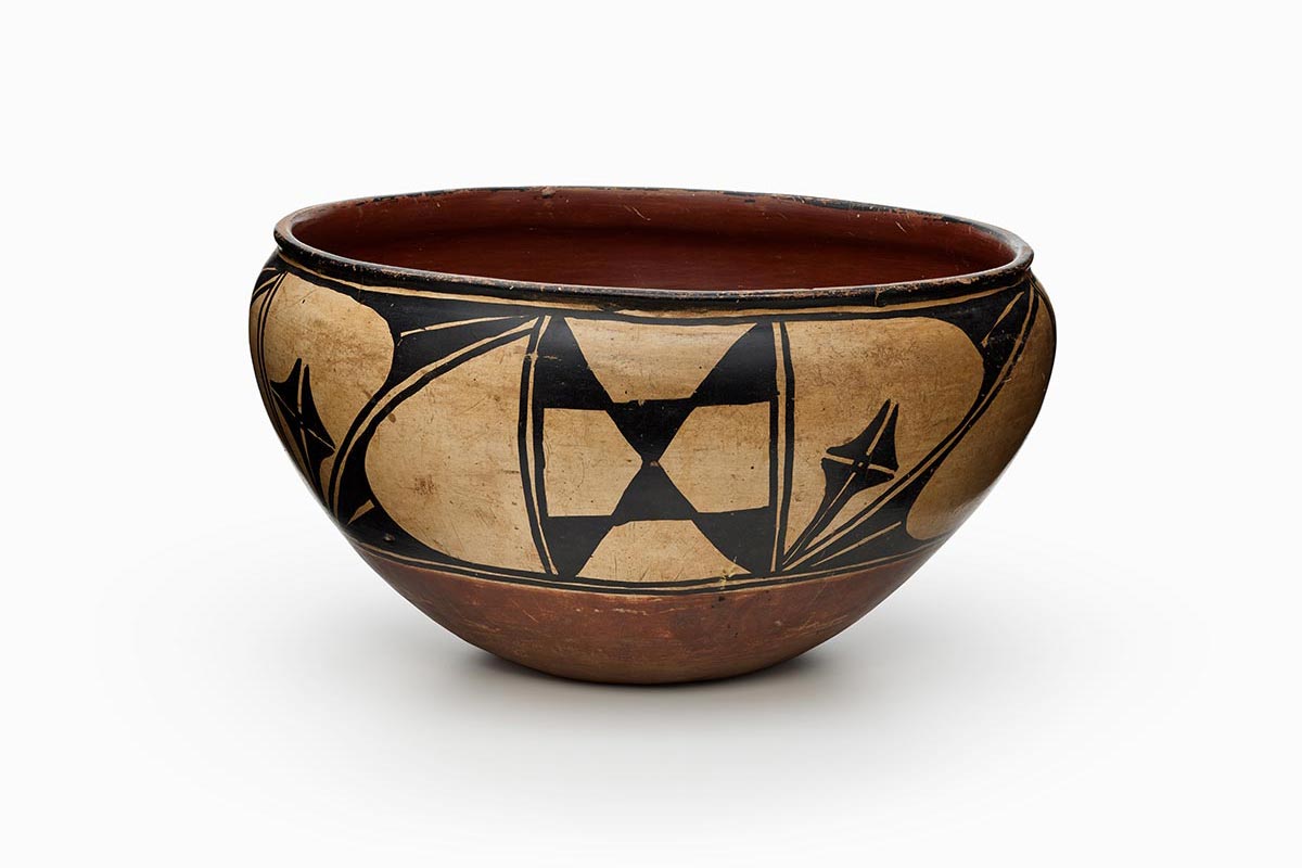 A three-color Kewa polychrome dough bowl features white slip with black and red painted decoration.
