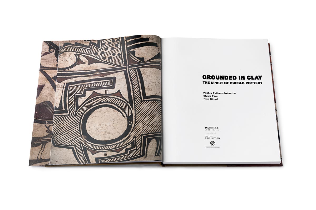 The Grounded in Clay exhibition catalogue opened on the table to the title page.