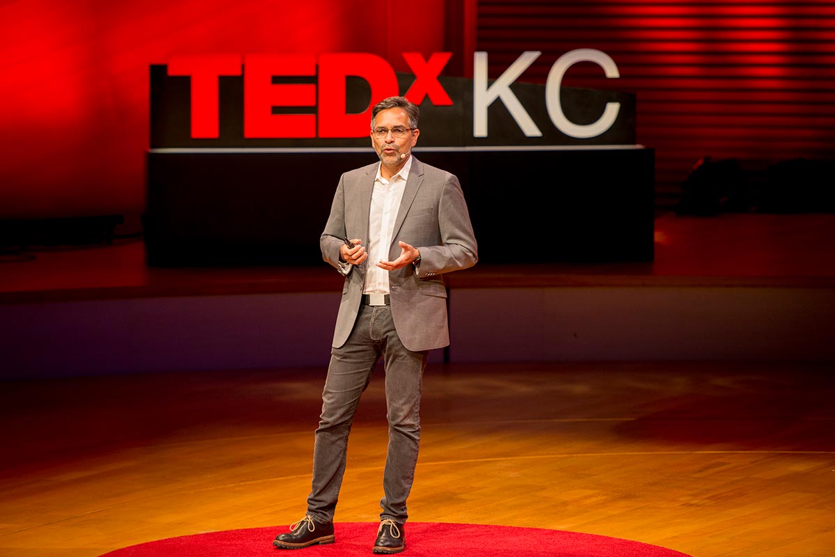 Alejandro Sánchez Alvarado standing on stage giving a TED Talk.