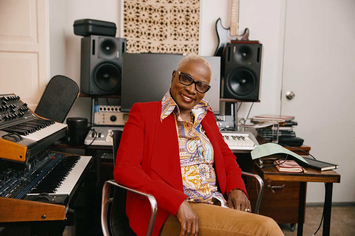 Angélique Kidjo sits in her studio in front of large speakers.