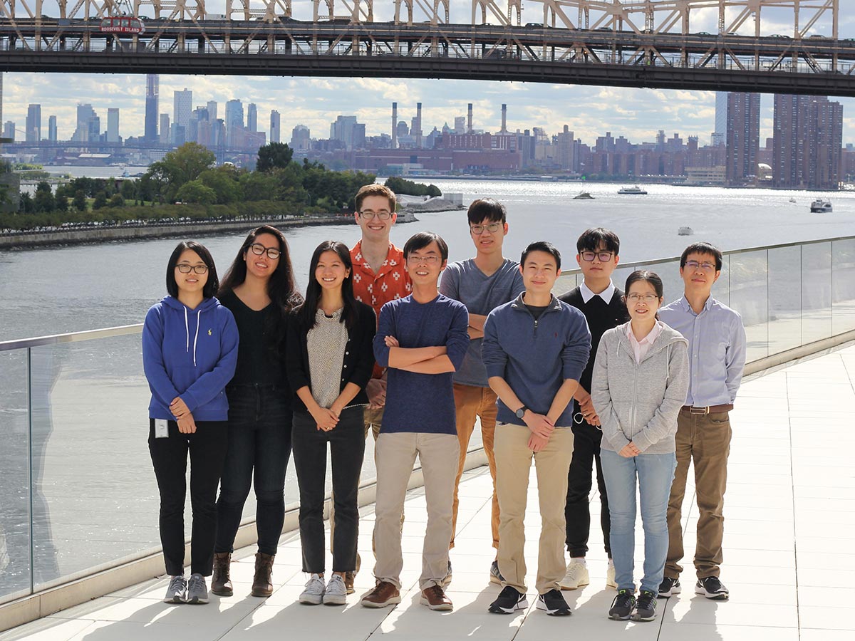 Shixin Liu with his colleagues with the NYC skyline behind them.