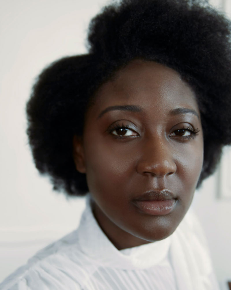 A portrait of Ellie Foumbi against a white background.