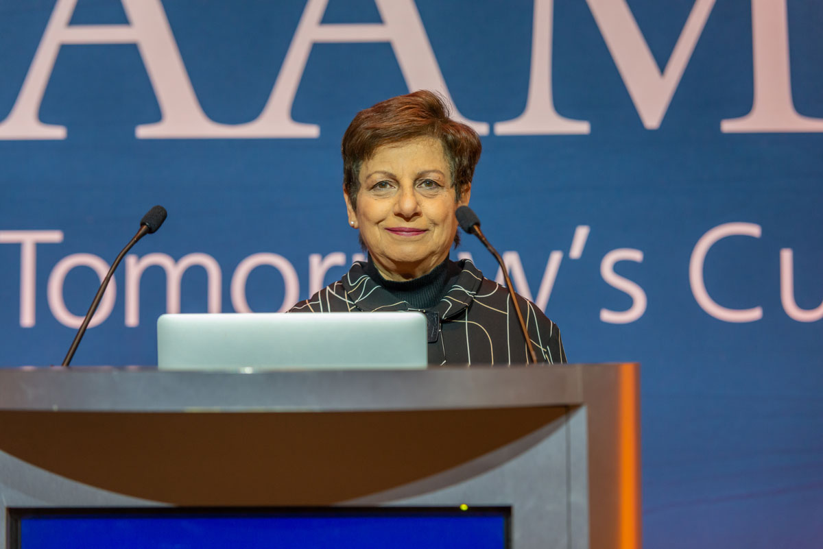 Mona Fouad standing behind the podium at the AAMC meeting.